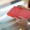 woman holding a red 2021 planner