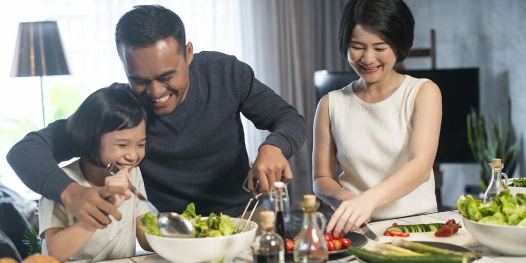 asian family preparing healthy food in the kitchen