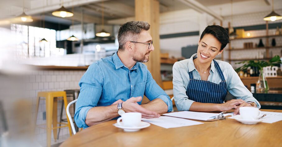 small business owner talking to an advisor on the table