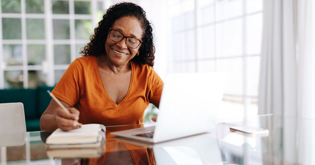 black African senior woman writing to plan ahead